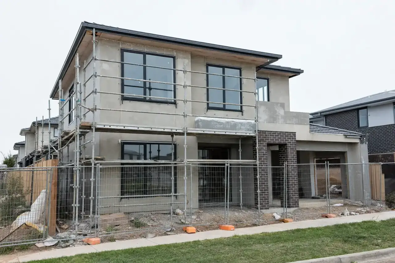 New double-storey house under construction in a new estate with black aluminium double glazed windows