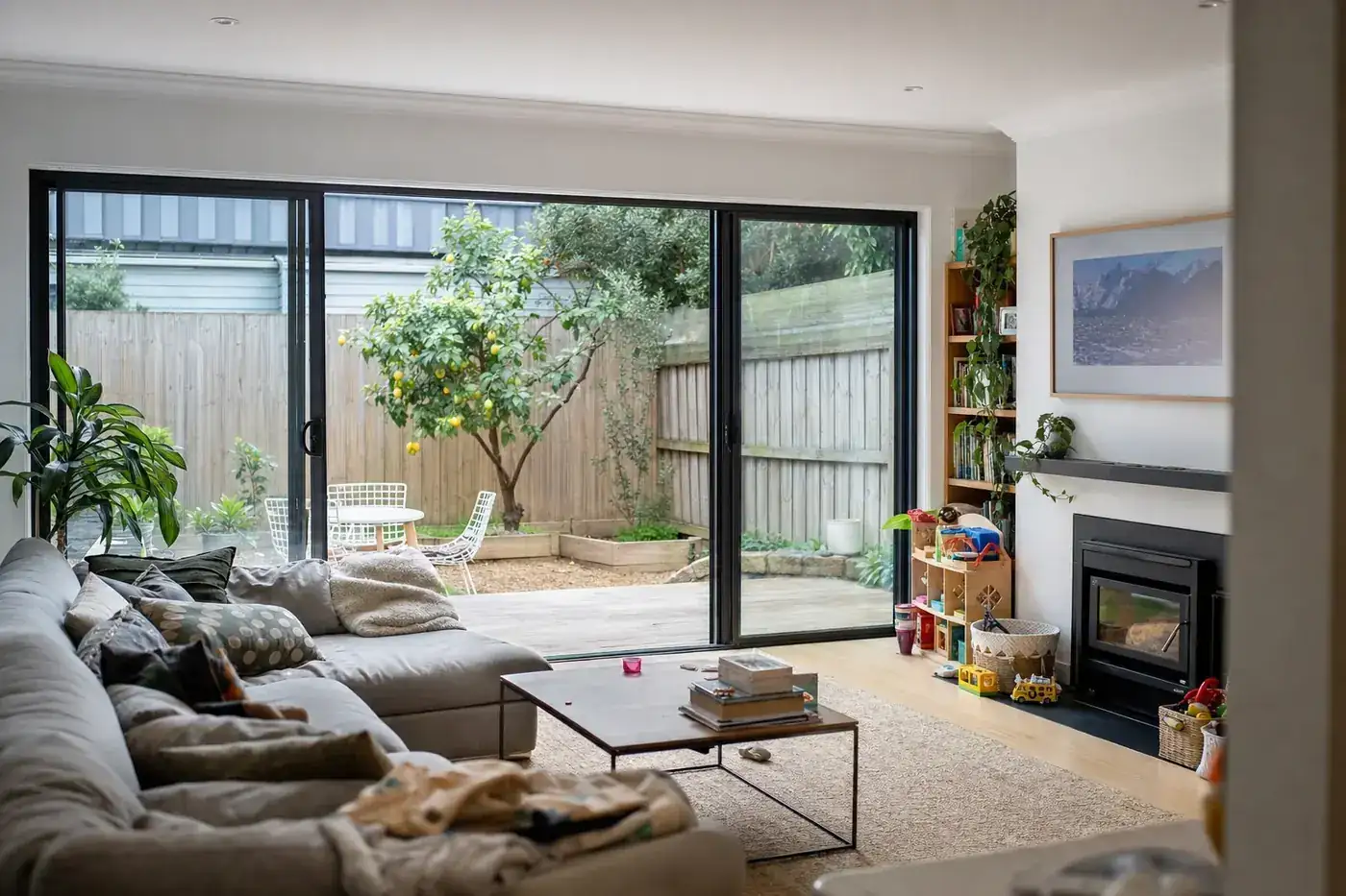 Living room of a renovated Californian bungalow with black aluminium double glazed windows
