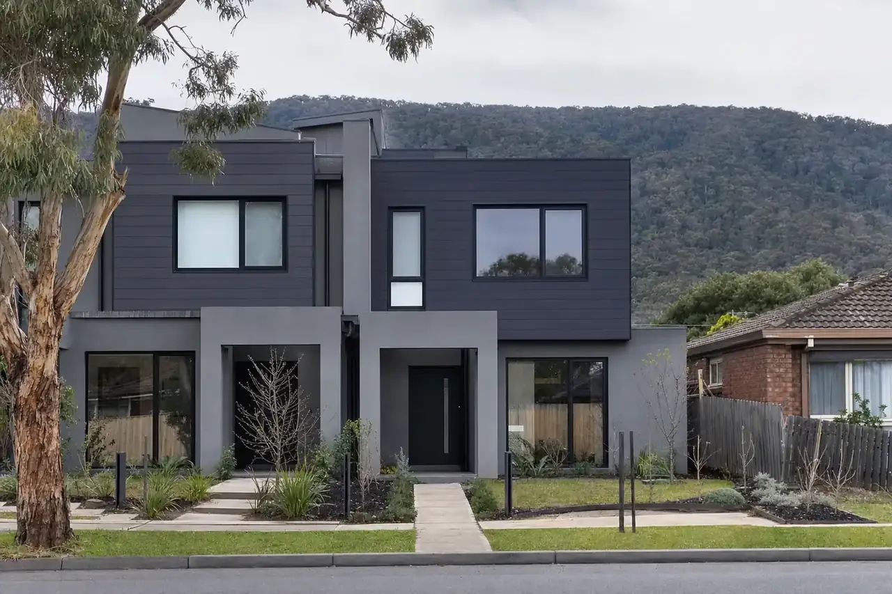 Front of a new two-storey townhouse pair with black aluminium double glazed windows